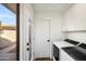 A laundry room with modern washer and dryer and white cabinetry at 4525 N 66Th St # 95, Scottsdale, AZ 85251