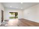 Empty room with hardwood flooring, recessed lighting and sliding glass doors to the backyard at 4525 N 66Th St # 95, Scottsdale, AZ 85251