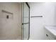 Walk-in shower featuring stone walls and a modern glass door at 4525 N 66Th St # 95, Scottsdale, AZ 85251