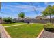 Large backyard with green grass, fire pit, pavers and string lights perfect for outdoor entertaining at 4595 W Foldwing Dr, San Tan Valley, AZ 85144