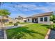 The backyard has a well-maintained lawn, covered patio, fire pit, and ample space for outdoor activities at 4595 W Foldwing Dr, San Tan Valley, AZ 85144