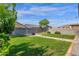 The backyard features manicured lawn, fire pit, string lights, and block wall fencing for added privacy at 4595 W Foldwing Dr, San Tan Valley, AZ 85144