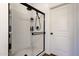 Modern bathroom featuring a glass shower with black trim and a white door at 4595 W Foldwing Dr, San Tan Valley, AZ 85144