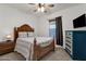 Bedroom with wooden bed frame, carpeted floors, and window with natural light at 4595 W Foldwing Dr, San Tan Valley, AZ 85144