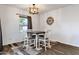 Dining area with modern chandelier and a large window for natural light at 4595 W Foldwing Dr, San Tan Valley, AZ 85144