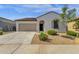 A charming home boasting a two-car garage, desert landscaping, and a well-maintained lawn at 4595 W Foldwing Dr, San Tan Valley, AZ 85144