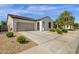 Charming single-story home featuring a two-car garage, neutral stucco, and low-maintenance desert landscaping at 4595 W Foldwing Dr, San Tan Valley, AZ 85144