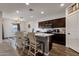 Kitchen island with granite countertops and wood floors with adjacent living and dining areas at 4595 W Foldwing Dr, San Tan Valley, AZ 85144