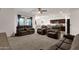Spacious living room with a view of the kitchen and dining area, with neutral decor and modern lighting at 4595 W Foldwing Dr, San Tan Valley, AZ 85144