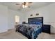 Spacious main bedroom featuring a ceiling fan, windows, and plush furnishings at 4595 W Foldwing Dr, San Tan Valley, AZ 85144