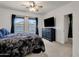 Spacious main bedroom with a TV, windows, and plush furnishings at 4595 W Foldwing Dr, San Tan Valley, AZ 85144