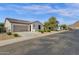 A view of the home's facade showcasing its desert landscaping in a well-maintained community at 4595 W Foldwing Dr, San Tan Valley, AZ 85144