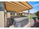 Relaxing backyard patio features a hot tub and covered pergola at 4721 N Aldea W Rd, Litchfield Park, AZ 85340