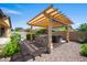 Outdoor kitchen and covered pergola with jacuzzi in manicured backyard at 4721 N Aldea W Rd, Litchfield Park, AZ 85340