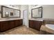 This bathroom features dual sinks with dark wood cabinets and large mirrors at 4721 N Aldea W Rd, Litchfield Park, AZ 85340