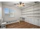 Bedroom with built-in shelving, window with shutters, and ceiling fan at 4721 N Aldea W Rd, Litchfield Park, AZ 85340