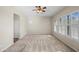 A bedroom with ceiling fan, carpet, and plantation shutters at 4721 N Aldea W Rd, Litchfield Park, AZ 85340
