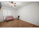 Bedroom with wood flooring, window with shutters, and modern seating at 4721 N Aldea W Rd, Litchfield Park, AZ 85340