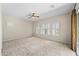 A bedroom with ceiling fan, carpet, and plantation shutters at 4721 N Aldea W Rd, Litchfield Park, AZ 85340