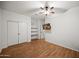 Bright bedroom featuring wood floors, closet, and a mounted television at 4721 N Aldea W Rd, Litchfield Park, AZ 85340