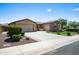 Lovely home featuring desert landscaping, an extended driveway, and a two-car garage, displaying a well-maintained exterior at 4721 N Aldea W Rd, Litchfield Park, AZ 85340