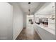 A hallway with tile floor and view of the living room and kitchen at 4721 N Aldea W Rd, Litchfield Park, AZ 85340