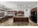 Spacious kitchen featuring dark wood cabinetry, granite countertops, stainless steel appliances, and an island with bar seating at 4721 N Aldea W Rd, Litchfield Park, AZ 85340