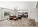 An open floor plan living room with tile floor, ceiling fan, and kitchen at 4721 N Aldea W Rd, Litchfield Park, AZ 85340