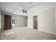 Spacious living room features plush carpet, neutral walls, and access to the outdoor patio at 4721 N Aldea W Rd, Litchfield Park, AZ 85340