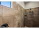 The stand up shower includes tiled walls with design features and a built in shelf at 4721 N Aldea W Rd, Litchfield Park, AZ 85340