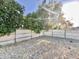 Fenced backyard with rock landscaping and mature trees at 4838 W Christine Cir, Glendale, AZ 85308