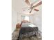 Bedroom featuring a ceiling fan, window with curtains, and a comfortable bed at 4838 W Christine Cir, Glendale, AZ 85308