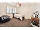 Bedroom with shuttered windows, ceiling fan, and carpet at 4838 W Christine Cir, Glendale, AZ 85308