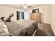 Cozy bedroom with patterned bedding, armoire, and ceiling fan at 4838 W Christine Cir, Glendale, AZ 85308