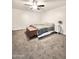 Bedroom featuring a ceiling fan, carpet, and a comfortable bed with bedside table at 4838 W Christine Cir, Glendale, AZ 85308