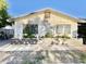 Front exterior of the home showcasing a flowerbed under the windows adding a touch of nature at 4838 W Christine Cir, Glendale, AZ 85308
