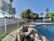 Relaxing backyard pool with rock feature, turf and view of palm trees at 4838 W Christine Cir, Glendale, AZ 85308