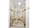 Walk-in shower featuring tile surround, glass doors, and stone pebble floor at 4838 W Christine Cir, Glendale, AZ 85308
