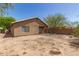 Wide backyard displaying a home's exterior, a patio, and a yard ready for customization and landscaping at 5439 W Sands Rd, Glendale, AZ 85301
