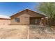 Backyard showcasing a home's exterior, a covered patio, and a spacious area ready for landscaping at 5439 W Sands Rd, Glendale, AZ 85301