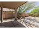 Relaxing covered backyard patio with a textured surface, views of the yard, and a mature tree at 5439 W Sands Rd, Glendale, AZ 85301