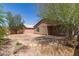 Expansive backyard view featuring desert landscaping, a home's exterior, and a covered patio area at 5439 W Sands Rd, Glendale, AZ 85301