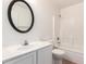 Well-lit bathroom featuring a large vanity with an oval mirror, a toilet, and a shower/tub combo at 5439 W Sands Rd, Glendale, AZ 85301