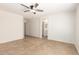 A spacious bedroom with tile floors and a view into the bathroom at 5439 W Sands Rd, Glendale, AZ 85301