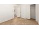 A well lit bedroom with tile floors and a closet at 5439 W Sands Rd, Glendale, AZ 85301