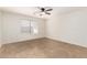 A spacious bedroom with neutral walls and tile floors plus a ceiling fan at 5439 W Sands Rd, Glendale, AZ 85301