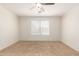 A well lit bedroom with tile floors, neutral walls and a ceiling fan at 5439 W Sands Rd, Glendale, AZ 85301