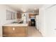 Bright kitchen features wood cabinets, white appliances and a breakfast bar with tile floors at 5439 W Sands Rd, Glendale, AZ 85301