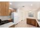 Bright kitchen with white appliances and tile floors plus a view of the adjacent room at 5439 W Sands Rd, Glendale, AZ 85301