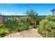 Beautiful backyard featuring lush plantings and a stone patio, perfect for outdoor relaxation at 6145 S Adelle --, Mesa, AZ 85212